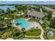 Aerial view of a large outdoor pool and clubhouse surrounded by lush landscaping in a residential community at 16027 Juniper Inlet Aly, Winter Garden, FL 34787