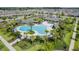 Aerial view of a community pool surrounded by palm trees and lounge chairs near homes at 16027 Juniper Inlet Aly, Winter Garden, FL 34787