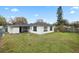 Well-maintained backyard featuring a lush lawn and a view of the home's exterior at 1607 31St Nw St, Winter Haven, FL 33881