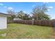 Large backyard with a wood fence, offering privacy and space for outdoor activities at 1607 31St Nw St, Winter Haven, FL 33881