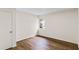 Bedroom featuring wood-look floors, a window bringing in natural light, and ample closet space at 1607 31St Nw St, Winter Haven, FL 33881