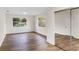 Bright bedroom with wood-look floors, two windows allowing natural light, and mirrored closet doors at 1607 31St Nw St, Winter Haven, FL 33881