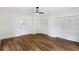 Living room with hard surface floor, white walls and trim, and a door leading to the yard at 1607 31St Nw St, Winter Haven, FL 33881