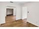 Bright living room with wood-look floors flowing through archway, creating an inviting and open space at 1607 31St Nw St, Winter Haven, FL 33881