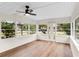 Bright sunroom filled with natural light from numerous windows and ceiling fan with hard surface floors at 1607 31St Nw St, Winter Haven, FL 33881