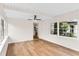 Bright sunroom has hard surface floors, ceiling fan, and view of the kitchen and back yard at 1607 31St Nw St, Winter Haven, FL 33881