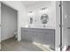 Bright bathroom featuring double sinks and modern vanity with gray cabinets at 16224 Sw 55Th Court Rd, Ocala, FL 34473
