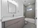 Bathroom with gray tiled shower, gray vanity and stone countertop at 16224 Sw 55Th Court Rd, Ocala, FL 34473