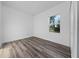 Bedroom featuring hardwood floors and a window with a view of greenery at 16224 Sw 55Th Court Rd, Ocala, FL 34473