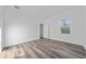 Bedroom with wood floors, white walls, and a bright window view at 16224 Sw 55Th Court Rd, Ocala, FL 34473