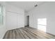 Bedroom featuring hardwood floors and a closet with folding doors at 16224 Sw 55Th Court Rd, Ocala, FL 34473