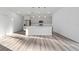 Living room with modern gray cabinets, stainless steel appliances and luxury vinyl flooring at 16224 Sw 55Th Court Rd, Ocala, FL 34473