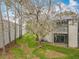 Rear exterior view shows the balconies overlooking the community lawn area and mature trees at 163 Springwood Cir # D, Longwood, FL 32750