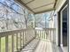 Balcony with wood decking and painted railing overlooks the community green space at 163 Springwood Cir # D, Longwood, FL 32750