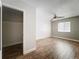 Bedroom featuring a ceiling fan, light gray walls, wood floors, and closet at 163 Springwood Cir # D, Longwood, FL 32750