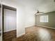 Bedroom featuring a ceiling fan, light gray walls, wood floors, and closet at 163 Springwood Cir # D, Longwood, FL 32750