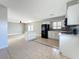 Kitchen featuring white cabinets, black appliances, mosaic backsplash and island at 163 Springwood Cir # D, Longwood, FL 32750