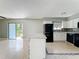 Bright kitchen featuring white cabinets, black appliances, mosaic backsplash and island at 163 Springwood Cir # D, Longwood, FL 32750