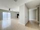 Open-concept living room featuring tile floors, a ceiling fan, and access to kitchen at 163 Springwood Cir # D, Longwood, FL 32750