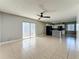 Inviting open-concept living space features tile floors, ceiling fan, and kitchen at 163 Springwood Cir # D, Longwood, FL 32750