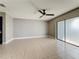 Expansive living space featuring tile flooring, ceiling fan, and access to a private balcony at 163 Springwood Cir # D, Longwood, FL 32750