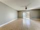Spacious living room featuring tile floors, a ceiling fan, and sliding glass doors to a balcony at 163 Springwood Cir # D, Longwood, FL 32750