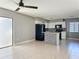 Open-concept living space with tile floors, ceiling fan, and access to updated kitchen at 163 Springwood Cir # D, Longwood, FL 32750