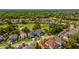 Aerial view of the neighborhood showcasing the lush landscaping, houses, and nearby golf course at 1714 Golfview Dr, Kissimmee, FL 34746