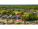 A beautiful property in a golf community featuring well-manicured lawns and mature trees at 1714 Golfview Dr, Kissimmee, FL 34746