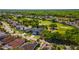 Aerial view of a neighborhood showcasing the lush green landscaping and golf course at 1714 Golfview Dr, Kissimmee, FL 34746