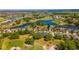 Picturesque aerial scene of a lakeside golf community with stunning blue water and manicured green spaces at 1714 Golfview Dr, Kissimmee, FL 34746