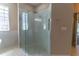 Modern bathroom features a glass-enclosed shower with a rain shower head and tiled flooring at 1714 Golfview Dr, Kissimmee, FL 34746