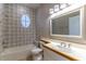 Well-lit bathroom features mosaic tile, a tub-shower combo, and a vanity with wood trim at 1714 Golfview Dr, Kissimmee, FL 34746
