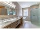Modern bathroom featuring double vanity, freestanding tub, glass block window and walk-in shower at 1714 Golfview Dr, Kissimmee, FL 34746