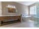 Modern bathroom with double vanity, freestanding tub, glass block window and walk-in shower at 1714 Golfview Dr, Kissimmee, FL 34746