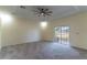 Bright bedroom with neutral carpet, a sliding glass door to screened porch, and tray ceiling at 1714 Golfview Dr, Kissimmee, FL 34746