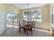 Bright dining area with chandelier, sliding glass door, and a large window offering outdoor view at 1714 Golfview Dr, Kissimmee, FL 34746