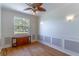 The formal dining room features wainscoting, hardwood floors, and a decorative ceiling fan at 1714 Golfview Dr, Kissimmee, FL 34746
