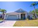 Charming single-story home with a well-maintained lawn, a two-car garage, and a welcoming front entrance at 1714 Golfview Dr, Kissimmee, FL 34746