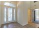 Bright foyer featuring a decorative glass front door, high ceilings, tile flooring, and neutral paint at 1714 Golfview Dr, Kissimmee, FL 34746
