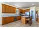 Spacious kitchen with stainless steel appliances, an island, wooden cabinets, and a view of backyard at 1714 Golfview Dr, Kissimmee, FL 34746
