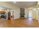 Open-concept living space with hardwood floors, stone fireplace, and adjacent kitchen at 1714 Golfview Dr, Kissimmee, FL 34746