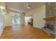 Bright living room boasts a stone fireplace, hardwood floors and sliding glass doors at 1714 Golfview Dr, Kissimmee, FL 34746