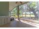 Enclosed patio featuring tile floors, a ceiling fan, and a large window view of the well-maintained backyard at 1714 Golfview Dr, Kissimmee, FL 34746