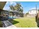 Relaxing backyard features a screened-in pool and ample green space at 2003 Woodcrest Dr, Winter Park, FL 32792