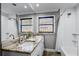 Bright bathroom featuring double sinks, granite countertops, and a shower-tub combination at 2003 Woodcrest Dr, Winter Park, FL 32792