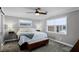 Comfortable bedroom featuring a ceiling fan, two windows, bench seat and bedside lamps at 2003 Woodcrest Dr, Winter Park, FL 32792