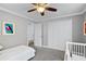 Bedroom with a closet and crib and door, providing a calm and inviting space at 2003 Woodcrest Dr, Winter Park, FL 32792