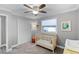 Charming Bedroom with wood crib, ceiling fan, and natural light from the window at 2003 Woodcrest Dr, Winter Park, FL 32792