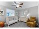 Well-appointed Bedroom with a crib, dresser, and a cozy rocking chair at 2003 Woodcrest Dr, Winter Park, FL 32792